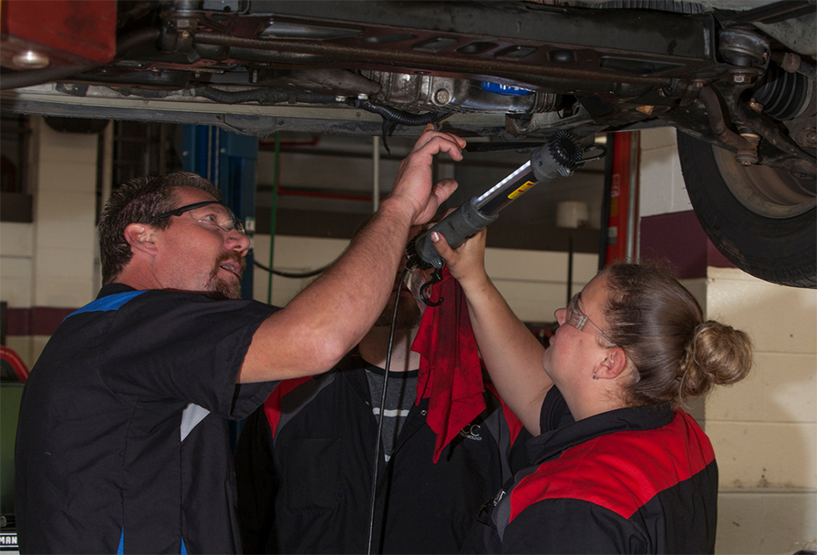 Girl learns to fix car in auto lab